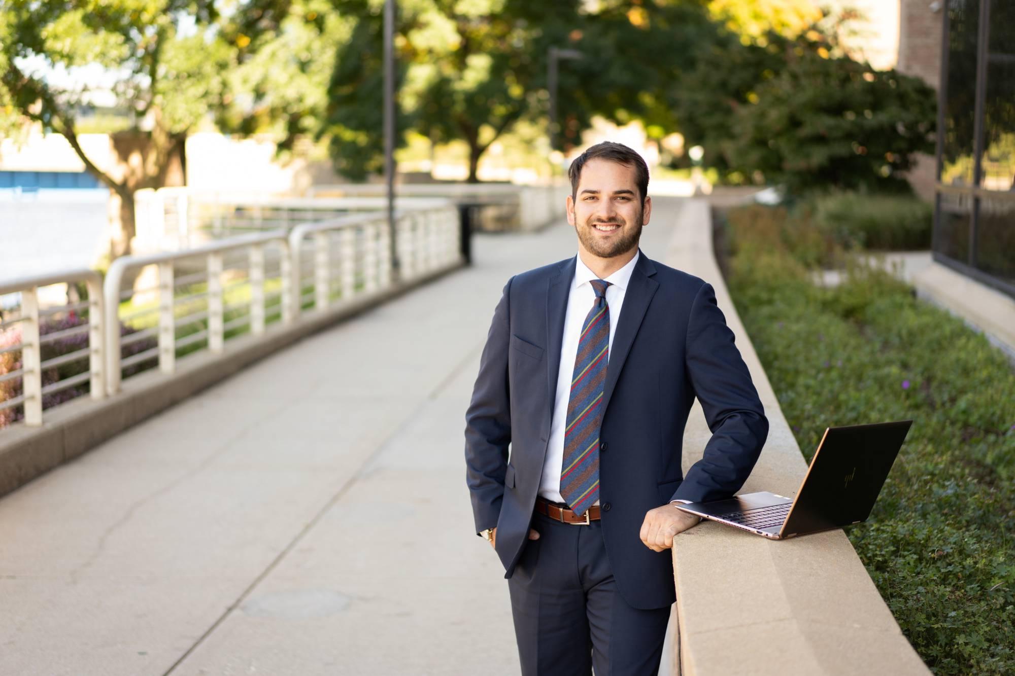 man standing with laptop